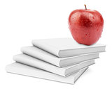 Fresh apple on stack of white books