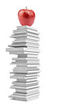 Fresh apple on pile of white books