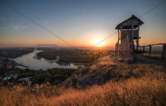 Wooden Tourist Observation Tower above a Little City with River 
