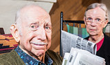 Elderly Man and Woman with Newspaper