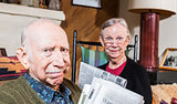 Elderly Husband and Wife with Newspaper
