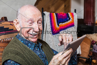 Smiling Older Gentleman with Tablet