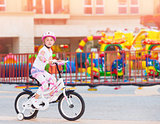 Happy little girl on the bicycle