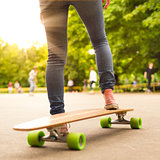 Teenage girl practicing riding long board.