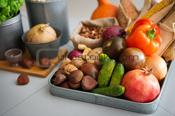 Closeup of Autumn fruits, vegetables, nuts on kitchen counter