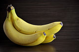 Fresh bananas on a dark background