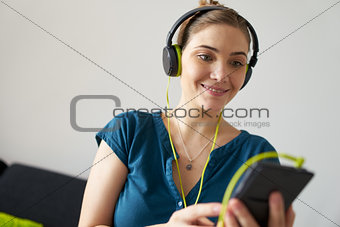 Woman With Green Earphones Listens Podcast Music On Telephone