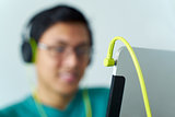 Asian Man With Green Headphones Listens Podcast Tablet PC