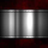 Shiny metal plate on a red grunge background