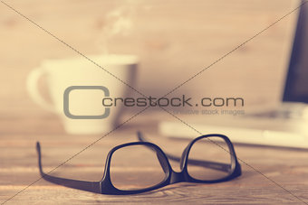 Glasses on wooden work table 
