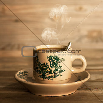 Steaming traditional oriental Chinese coffee in vintage mug and 