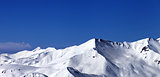 Panoramic view on off-piste snowy slope at sunny day