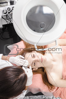 Young woman getting dermall fillers injection