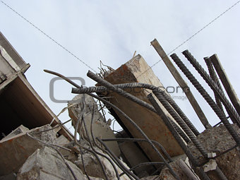 large concrete chunks with twisted metal on a demolition site