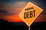 Debt on Warning Road Sign.