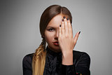beautiful woman portrait with hand in front of face