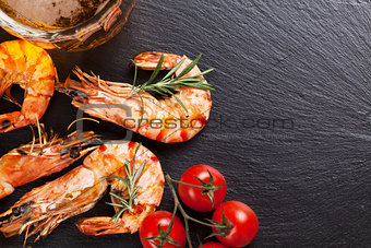 Beer mug and grilled shrimps on stone plate
