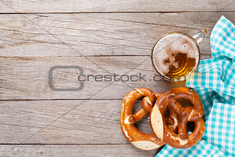 Beer mug and pretzel on wooden table