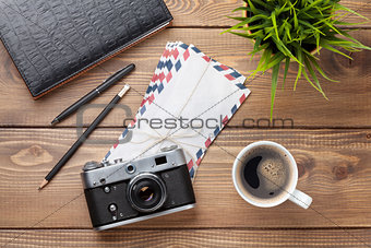 Camera and supplies on office wooden desk