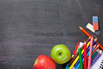 School supplies on blackboard background