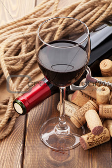 Glass of red wine, bottle and corks