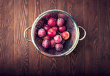Fresh plums on wooden board