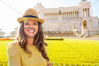 Smiling woman tourist in front of the Venice Square in Rome