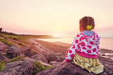 Adorable little girl looking at the sunset