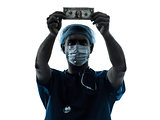 doctor surgeon man examing dollar bill silhouette