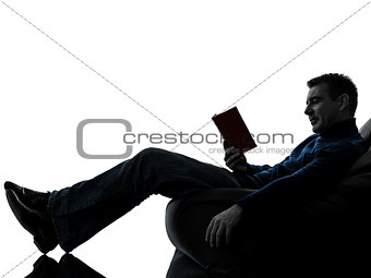 man reading book silhouette full length