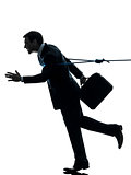 business man catched by lasso rope silhouette