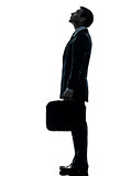 business man standing looking up silhouette