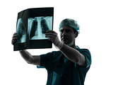 doctor surgeon radiologist examining lung torso  x-ray image sil