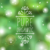 Pure organic - product label on blurred background.