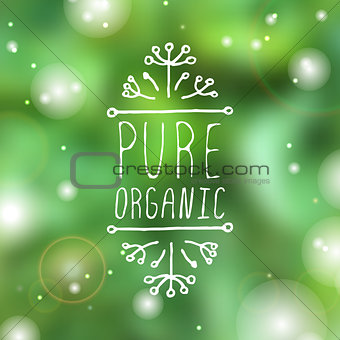 Pure organic - product label on blurred background.