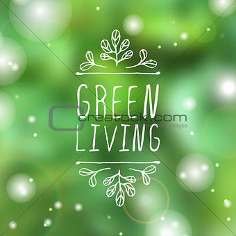 Green living - product label on blurred background.
