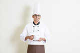 Indian male chef in uniform holding a coffee cup