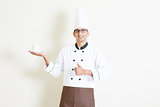 Indian male chef in uniform presenting a coffee cup and thumb up