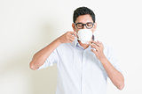 Casual business Indian male drinks coffee