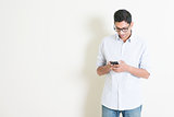 Casual business Indian male using smartphone
