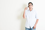 Casual business Indian male talking on smartphone