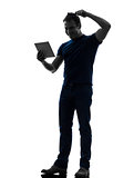 man holding digital tablet  brushing hair silhouette