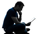man sitting holding watching digital tablet  silhouette