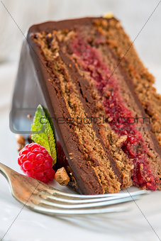 Piece of chocolate cake with raspberries.