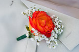 boutonniere of roses in the men's jacket