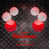 Christmas baubles and text over black metal plate