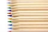 Row of colorful pencils macro on white 