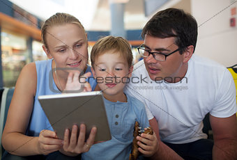 Parents and son with tablet PC at the airport
