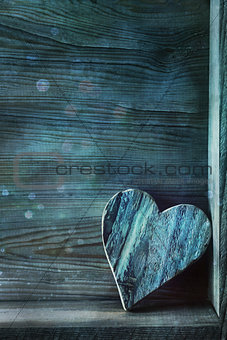 Blue wooden heart on wood