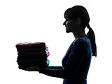 woman maid housework holding sweater pile silhouette